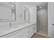 Modern bathroom with double sinks, quartz countertop, and a tiled shower at 18124 Goliad Ave, Port Charlotte, FL 33954