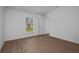 Clean, bright bedroom with wood floors and a view to the outside at 18124 Goliad Ave, Port Charlotte, FL 33954