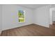 Bright and airy bedroom with wood floors and large window overlooking the backyard at 18124 Goliad Ave, Port Charlotte, FL 33954