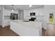 Well-lit kitchen featuring stainless steel appliances, white cabinets, and a spacious island at 18124 Goliad Ave, Port Charlotte, FL 33954