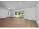 Open-concept living area with large sliding glass doors and wood-look floors at 18124 Goliad Ave, Port Charlotte, FL 33954