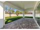 View of the paved patio leading out to the green lawn and fenced yard at 18124 Goliad Ave, Port Charlotte, FL 33954