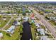 A waterfront home features a private dock, lush landscaping, and a sparkling pool at 21194 Edgewater Dr, Port Charlotte, FL 33952
