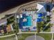 Stunning aerial view of a community pool, surrounded by lush landscaping, beach access, and resort-style amenities at 21194 Edgewater Dr, Port Charlotte, FL 33952