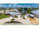 Waterfront property featuring mature landscaping, circular driveway, and boat parking in a quiet neighborhood at 21194 Edgewater Dr, Port Charlotte, FL 33952