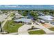 Waterfront property featuring mature landscaping, circular driveway, and boat parking in a quiet neighborhood at 21194 Edgewater Dr, Port Charlotte, FL 33952