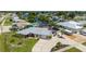 Waterfront property featuring mature landscaping, circular driveway, and boat parking in a quiet neighborhood at 21194 Edgewater Dr, Port Charlotte, FL 33952