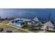 Aerial view of a park featuring a fenced swimming pool, pier, and ocean views at 21194 Edgewater Dr, Port Charlotte, FL 33952