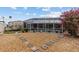 Screened pool enclosure surrounded by landscaped gravel and stone pathway in backyard at 21194 Edgewater Dr, Port Charlotte, FL 33952