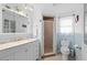 Bright bathroom featuring a white vanity, framed glass shower, and blue accents, offering a clean and functional space at 21194 Edgewater Dr, Port Charlotte, FL 33952