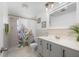 Clean bathroom featuring a gray vanity, tile floors, shower and neutral decor, offering a functional and serene space at 21194 Edgewater Dr, Port Charlotte, FL 33952