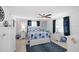 Serene bedroom with blue and white bedding, ceiling fan, dresser and coordinated decor for a peaceful retreat at 21194 Edgewater Dr, Port Charlotte, FL 33952