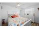 Bright bedroom with vibrant, colorful bedding, ceiling fan, white furniture and a neutral walls, creating a cheerful retreat at 21194 Edgewater Dr, Port Charlotte, FL 33952