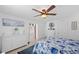 Relaxing bedroom features tile floors, a ceiling fan and view to doorway, and coordinating décor at 21194 Edgewater Dr, Port Charlotte, FL 33952