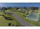 Aerial view of community recreation with pickle ball court, basket ball court and playground, near the bay at 21194 Edgewater Dr, Port Charlotte, FL 33952