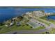 Aerial view of community recreation area with playground, pickleball, tennis, and basketball courts, parking, and a pier at 21194 Edgewater Dr, Port Charlotte, FL 33952