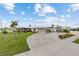Charming single-story home with a wide driveway, two-car garage, and well-maintained lawn, exuding curb appeal and comfort at 21194 Edgewater Dr, Port Charlotte, FL 33952