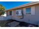 Exterior of home with a mini split system, white fence, garden, and manicured lawn at 21194 Edgewater Dr, Port Charlotte, FL 33952
