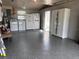 An organized garage area with appliances, a door, and smooth, speckled flooring at 21194 Edgewater Dr, Port Charlotte, FL 33952