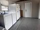 A well-organized garage area featuring modern appliances, a door, and durable flooring at 21194 Edgewater Dr, Port Charlotte, FL 33952