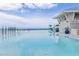 Relax by the infinity pool with amazing water views from this modern building at 21194 Edgewater Dr, Port Charlotte, FL 33952