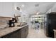 Galley kitchen with granite counters, modern appliances, and a sunroom at 21194 Edgewater Dr, Port Charlotte, FL 33952
