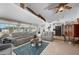 Bright living room with vaulted ceiling, tile floors, comfortable seating and a ceiling fan, creating a welcoming atmosphere at 21194 Edgewater Dr, Port Charlotte, FL 33952