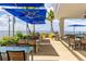 Outdoor patio with tables, chairs and umbrellas overlooking the bay at 21194 Edgewater Dr, Port Charlotte, FL 33952