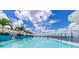 Gorgeous waterfront pool area with palm trees, lounges and views at 21194 Edgewater Dr, Port Charlotte, FL 33952