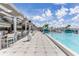 Chic rooftop pool with bar and lounge area, city views, shade trellis, and stylish decor at 21194 Edgewater Dr, Port Charlotte, FL 33952