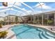 Gorgeous screened-in pool with an outdoor kitchen and ample space for entertaining at 21194 Edgewater Dr, Port Charlotte, FL 33952