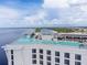 A luxury rooftop pool with an infinity edge, featuring a panoramic view of the coastline and lush landscaping at 21194 Edgewater Dr, Port Charlotte, FL 33952