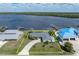 Home with waterfront access, lush landscaping, and a circular driveway at 2308 Harbour Dr, Punta Gorda, FL 33983