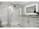 Bathroom featuring a glass shower with rainfall shower head and modern white vanity at 2308 Harbour Dr, Punta Gorda, FL 33983