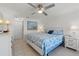 Bright bedroom with ceiling fan and decorated with beach-themed colors at 2308 Harbour Dr, Punta Gorda, FL 33983