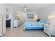 Bright bedroom with ceiling fan and decorated with beach-themed colors at 2308 Harbour Dr, Punta Gorda, FL 33983