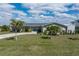 Charming single-story home featuring a well-manicured lawn and complemented by mature palm trees at 2308 Harbour Dr, Punta Gorda, FL 33983