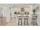 Modern kitchen featuring a breakfast bar, stainless steel appliances, and elegant lighting at 2308 Harbour Dr, Punta Gorda, FL 33983