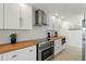 Well-equipped kitchen with stainless steel appliances and bright butcher block countertops at 2308 Harbour Dr, Punta Gorda, FL 33983