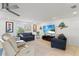 Well-lit living area with tile flooring, comfortable seating, and a wall-mounted television at 2308 Harbour Dr, Punta Gorda, FL 33983