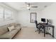 Office space featuring a modern ceiling fan, futon, desk, and tile floors at 2308 Harbour Dr, Punta Gorda, FL 33983