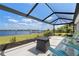 Screened lanai featuring outdoor seating with a table and a view of the waterfront at 2308 Harbour Dr, Punta Gorda, FL 33983