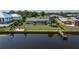 Aerial view of a waterfront home with a private dock, fire pit, and fenced yard at 2308 Harbour Dr, Punta Gorda, FL 33983