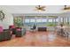 Bright sunroom with tile floors, comfortable seating, and expansive water views through large windows at 2308 Harbour Dr, Punta Gorda, FL 33983