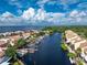 Aerial view of canal with boat docks and waterfront townhouses at 25188 Marion Ave # E409, Punta Gorda, FL 33950