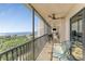 Enjoy breathtaking ocean views from this balcony featuring chairs and a ceiling fan at 25188 Marion Ave # E409, Punta Gorda, FL 33950