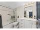 Well-lit bathroom showcasing a bathtub with shower, toilet, and vanity with modern fixtures at 25188 Marion Ave # E409, Punta Gorda, FL 33950