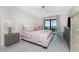 Bright bedroom features a ceiling fan and sliding glass door to private balcony at 25188 Marion Ave # E409, Punta Gorda, FL 33950