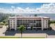Exterior shot of a well-maintained condo building with covered parking and scenic water views at 25188 Marion Ave # E409, Punta Gorda, FL 33950