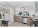 Bright kitchen with marble counters, modern appliances, and an adjacent dining area at 25188 Marion Ave # E409, Punta Gorda, FL 33950